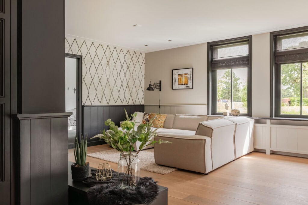 Cozy living room interior with large windows and natural light, modern and comfortable, perfect for a home in the farmhouse in Heerhugowaard.