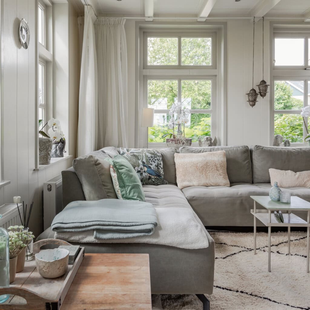 Bright living room in a farmhouse with soft green accessories