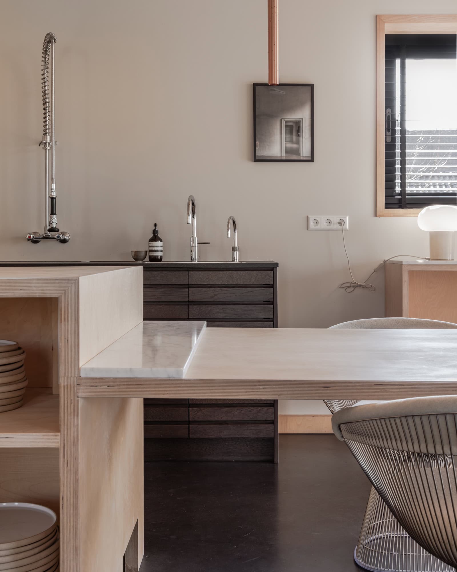 A plywood kitchen with an attached dining table. Modern look.