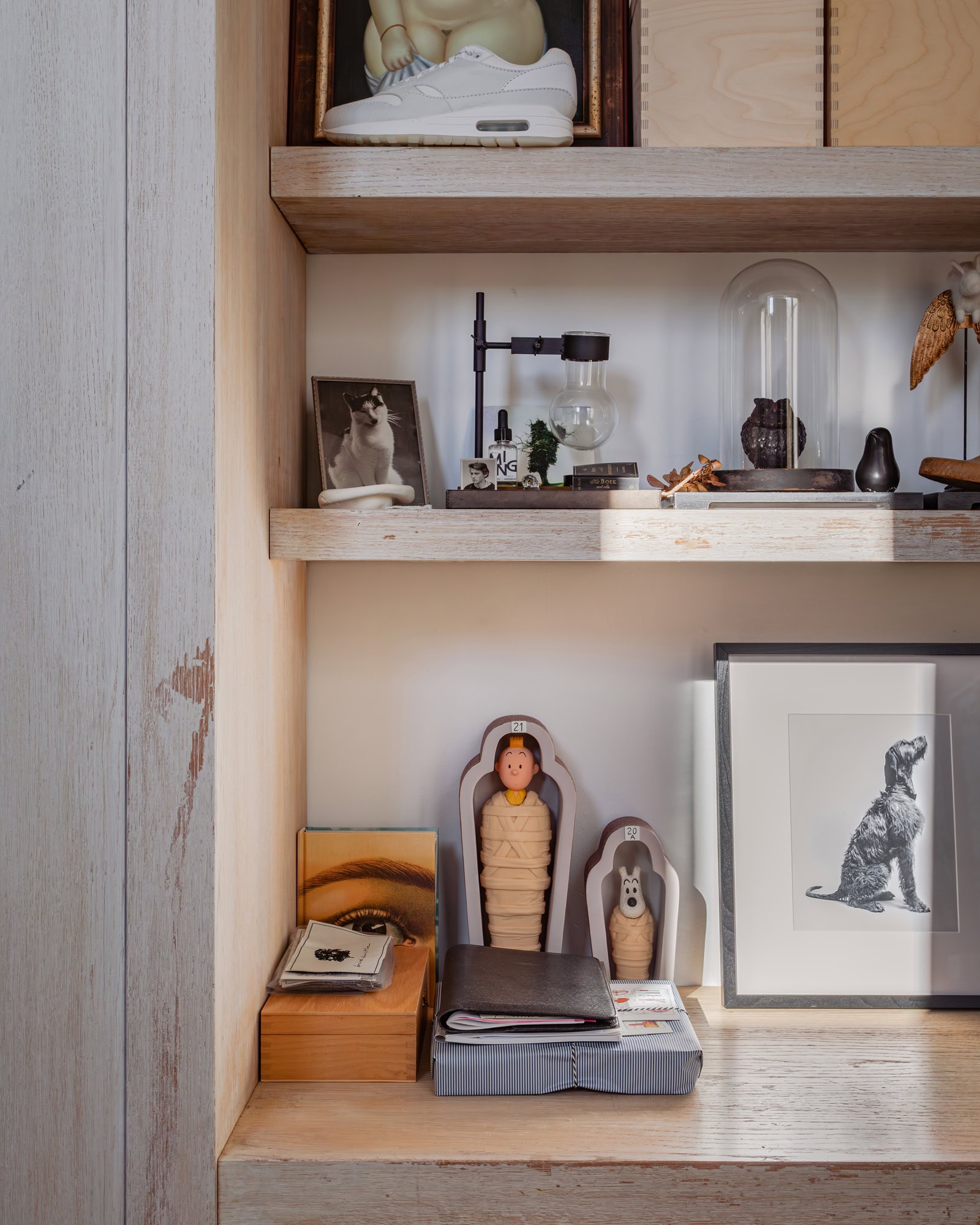 A detail of a cabinet in a workspace with a collection of unique accessories.